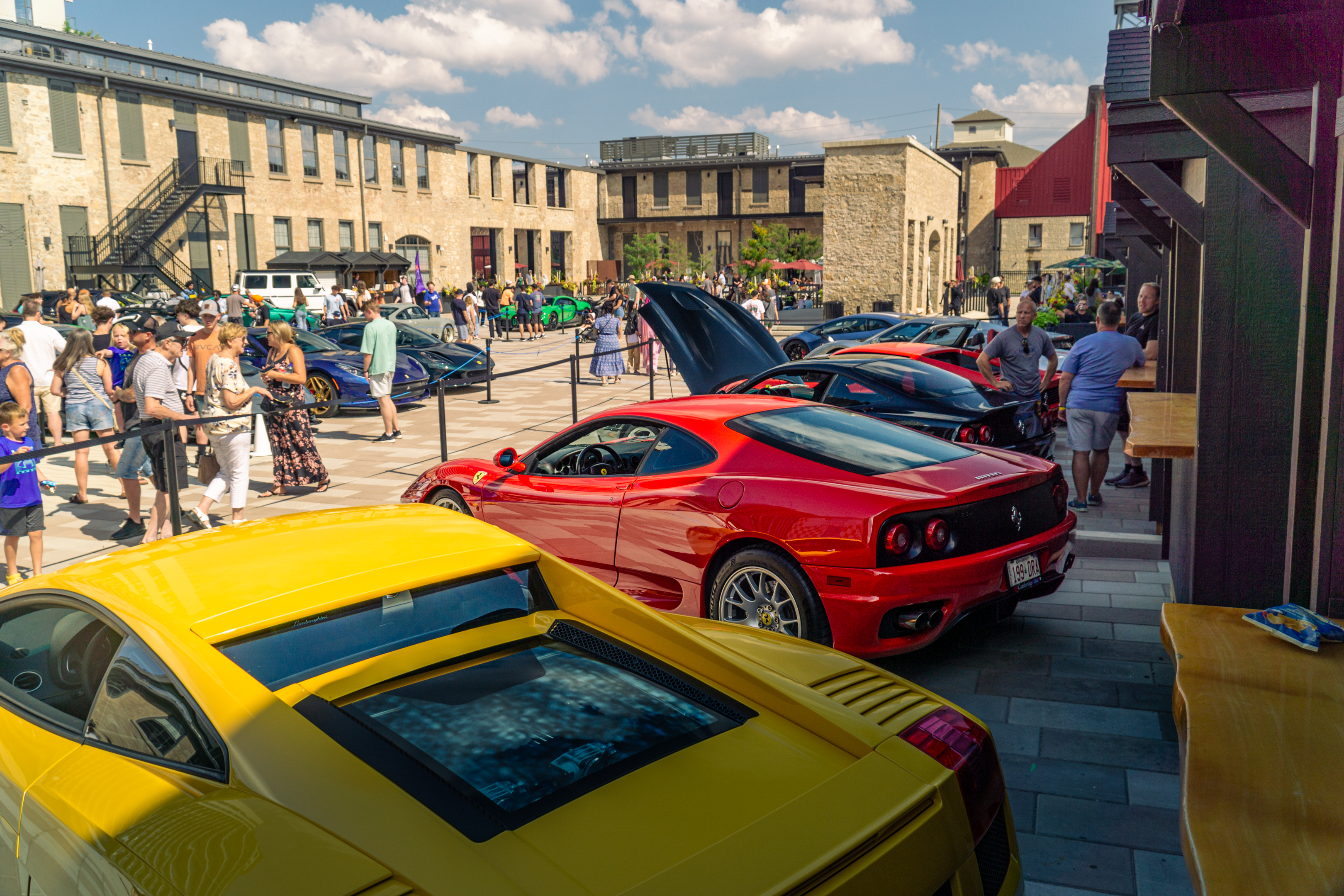 Guests gathering among colourful cars at an Incline event