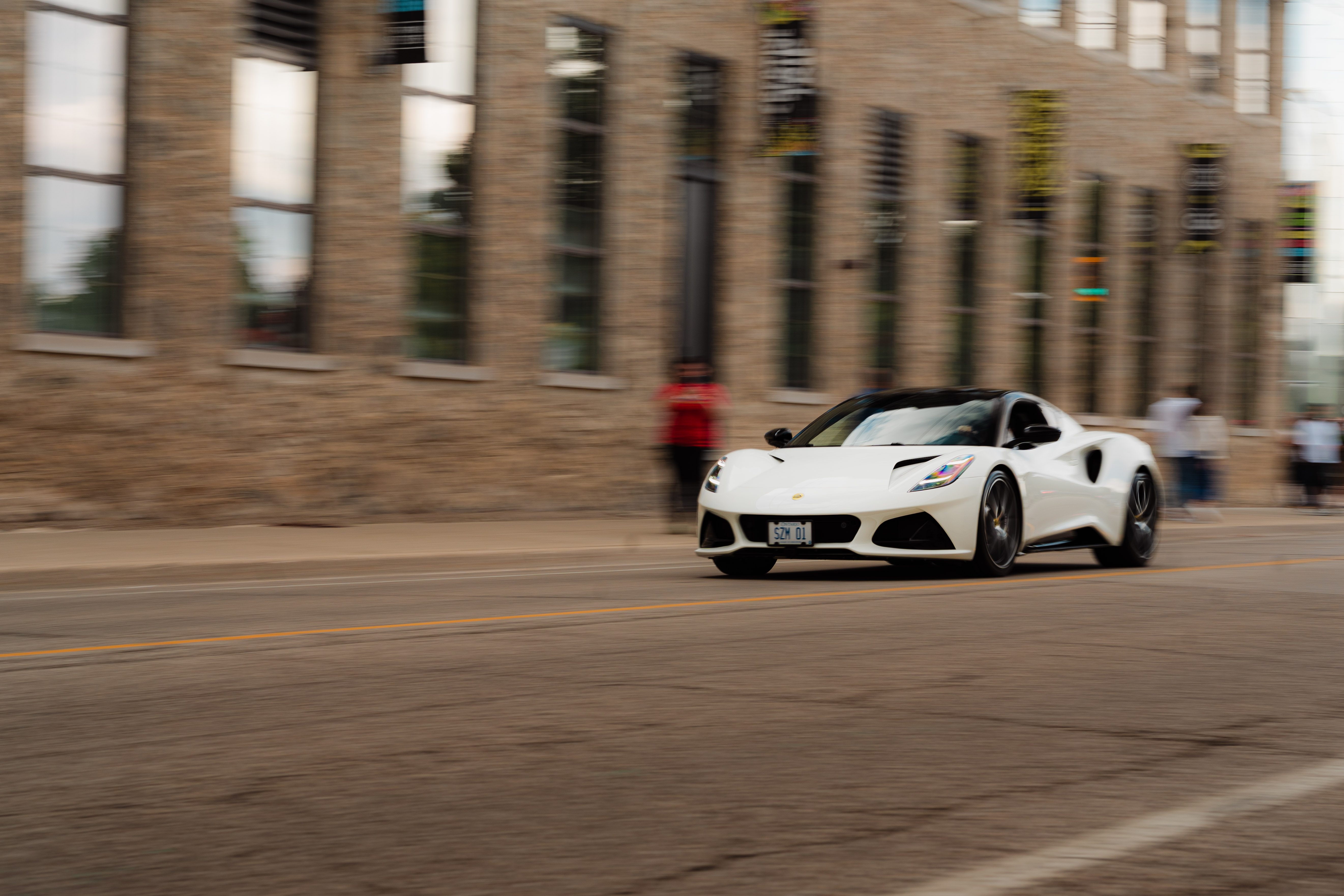 White sports car in motion through Cambridge